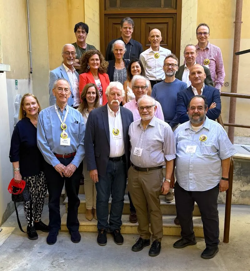 Symposium attendees gathered on the steps of a courtyard at the Temple University Rome Campus